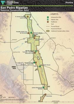 A map of the San Pedro Riparian National Conservation Area in Cochise County, southeastern Arizona. The NCA boundary is shown with a dark olive outline following the San Pedro River from the United States-Mexico border northward. The San Pedro River is shown in blue running the length of the NCA. Named sites shown include Fairbank Historic Townsite, Lehner Mammoth Kill Site, Little Boquillas Ranch, Millville Historic Townsite and Rock Art Discovery Trail, and more.