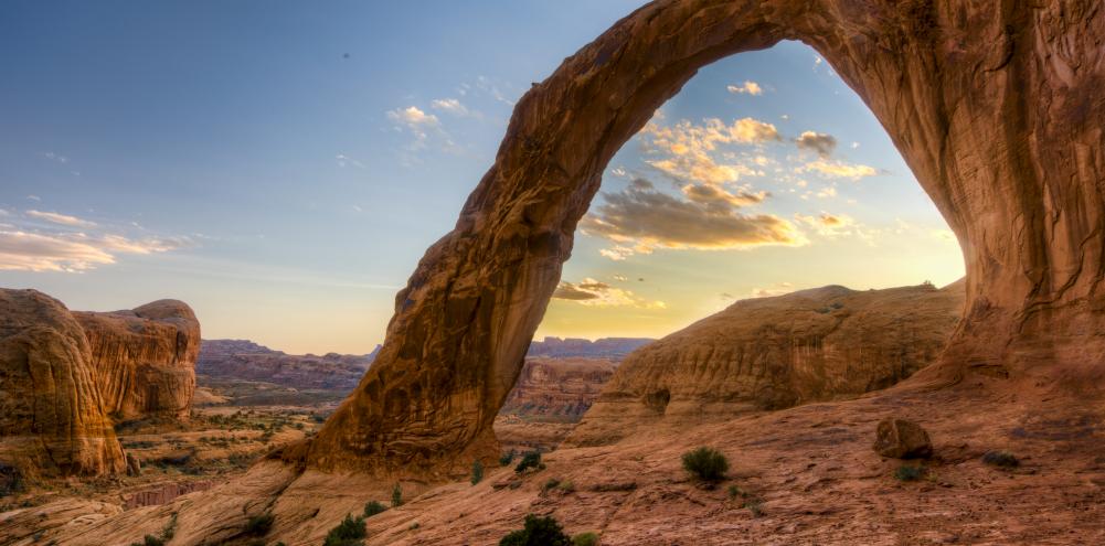 A rock arch framing a cloud