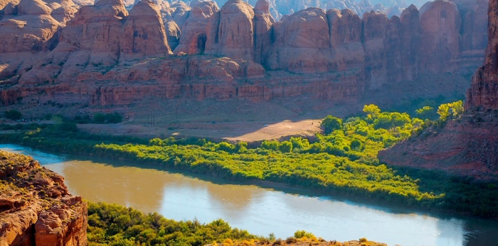 An arch with mountains and canyons. 