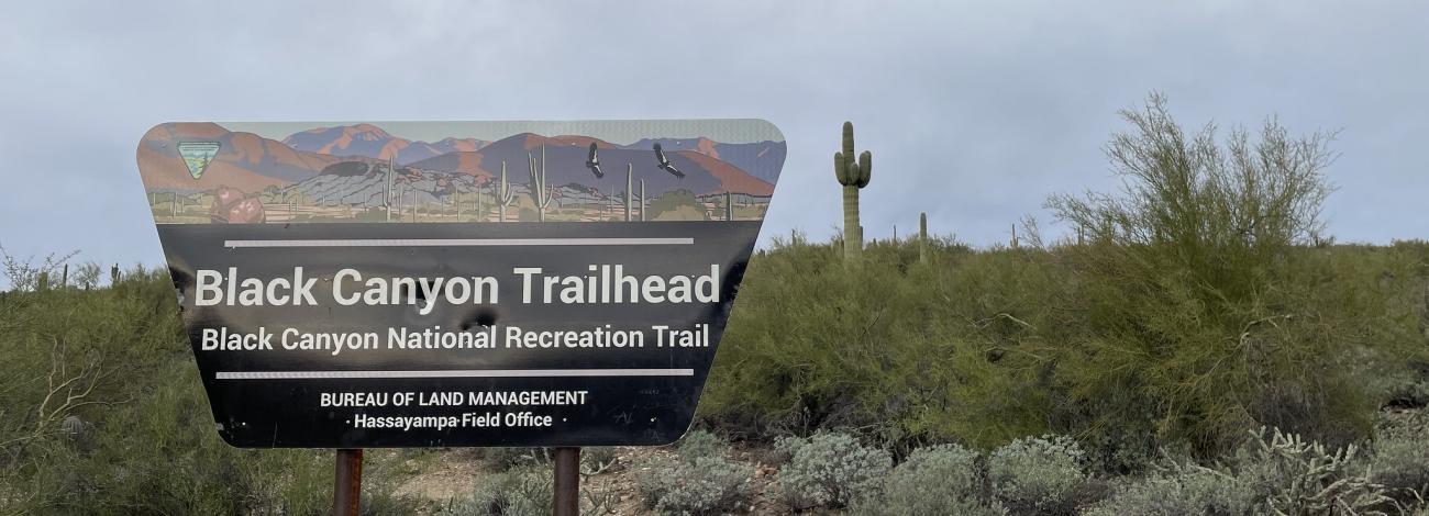 a trapezoid shaped sign reads Black Canyon Trailhead, Black Canyon National Recreation Trail