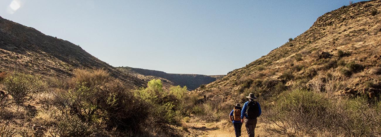 Two people hike Badger Springs Trail in Agua Fria National Monument
