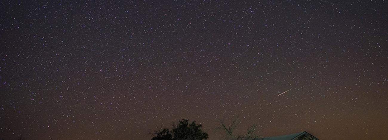 Sky glow from Las Vegas and starry nights dress up the remote Grand Gulch Mine bunkhouse.