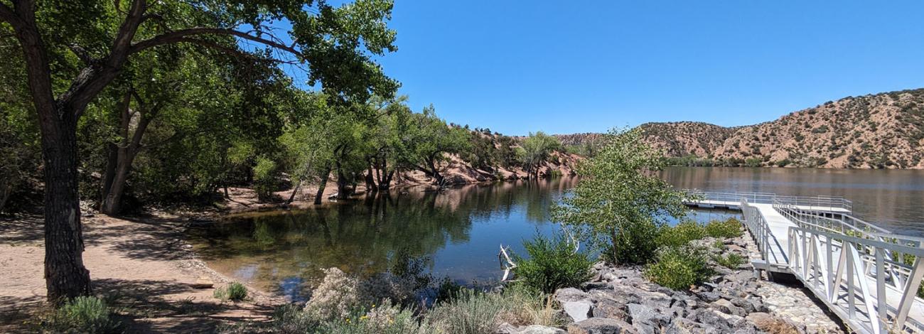 A left view of the lake and boat dock at Santa Cruz Lake Recreation Area.