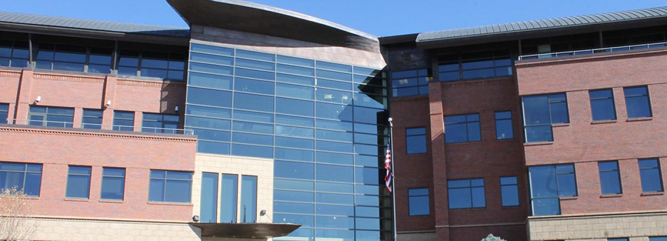 A forward looking wide view of the front entrance to the four story tall building