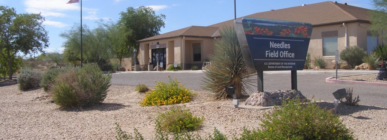 photo of office sign and building with desert landscaping