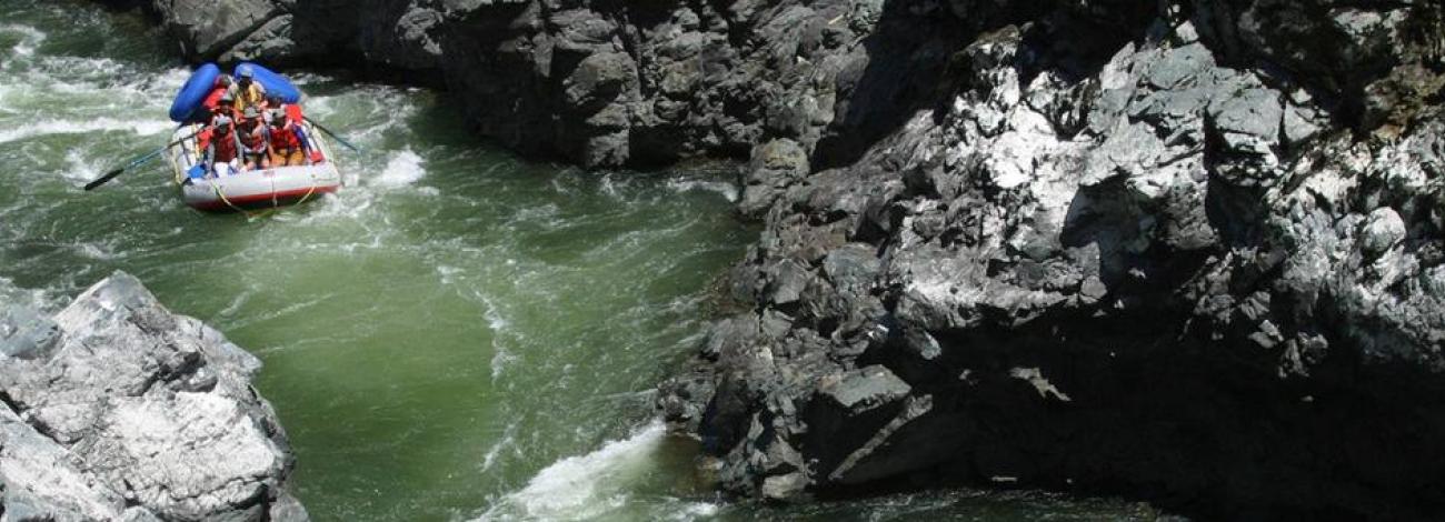 A rafter navigates through the narrow, rocky walls of Mule Creek Canyon on the Rogue River.