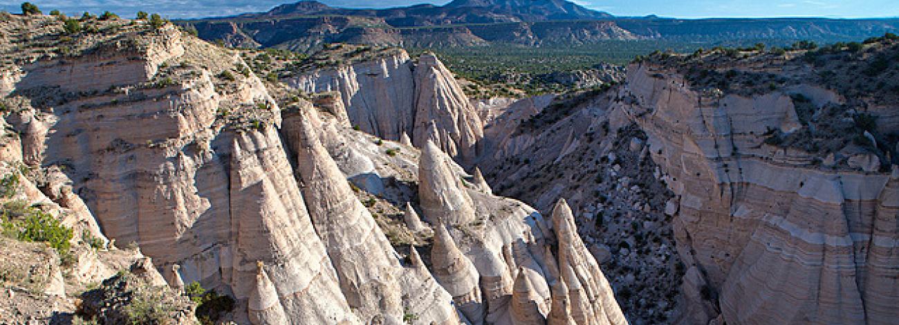 The cone-shaped tent rock formations against a blue sky at Kasha-Katuwe Tent Rocks National Monument.