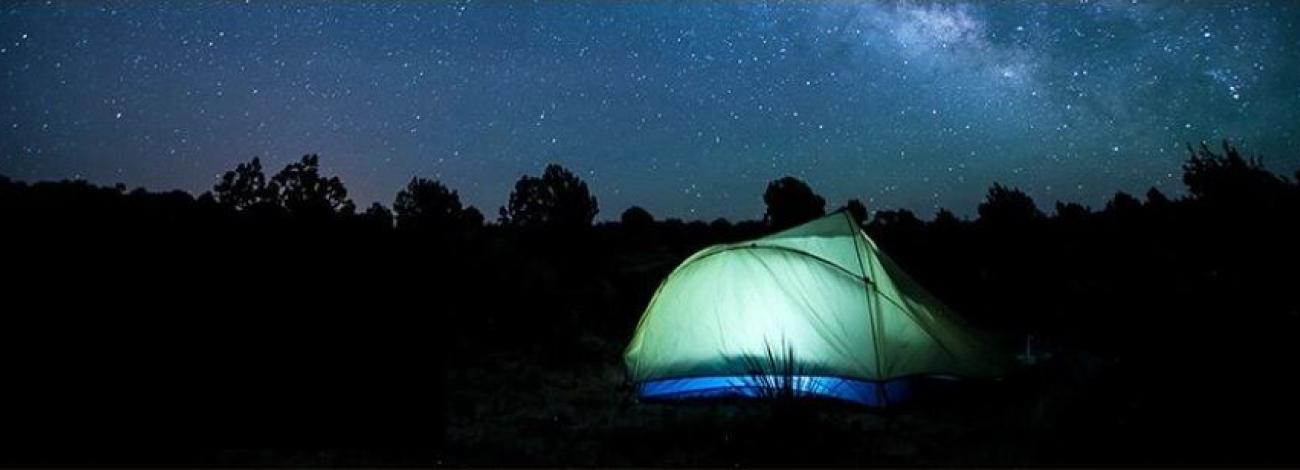 Tent camping under a starry night.