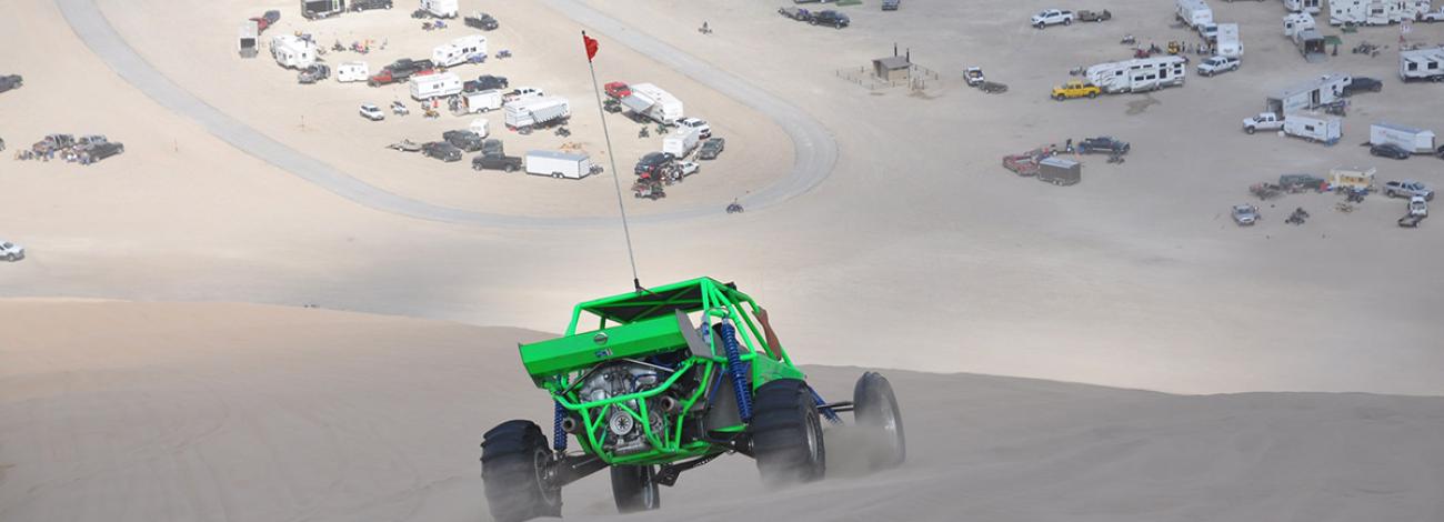 Dune buggy driving across sand dunes