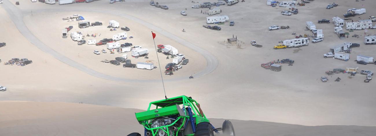 Dune buggy driving across sand dunes