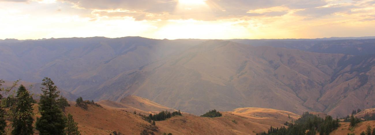 beam of sunlight breaks through the clouds onto Hells Canyon Wilderness Area