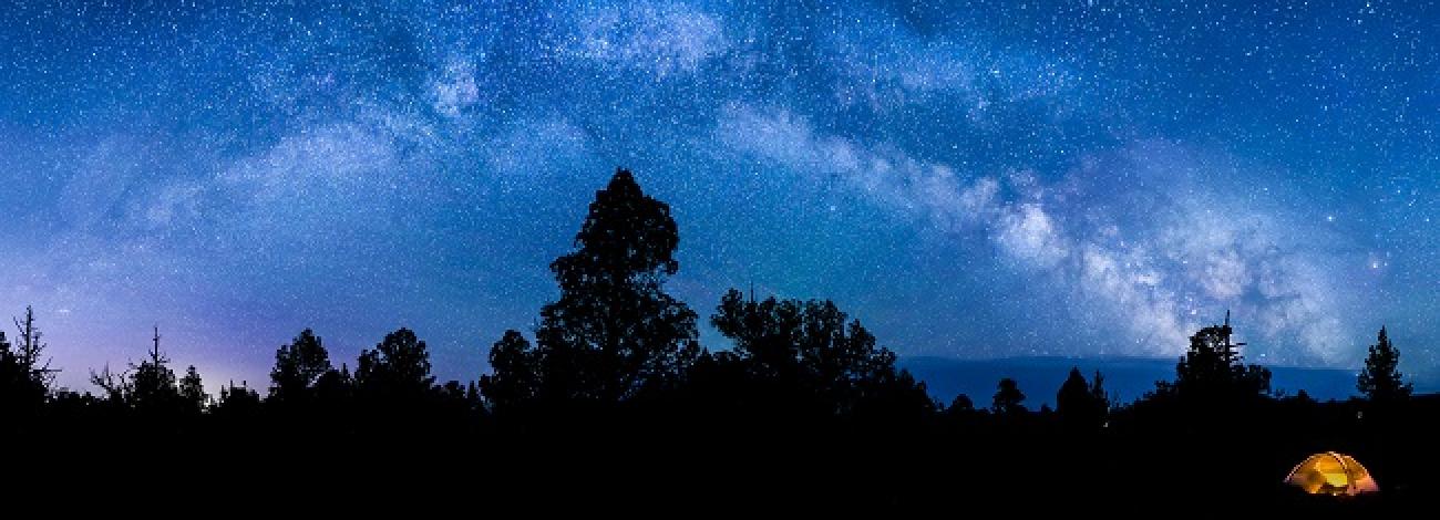 The night sky, stars, and a glowing tent within the Oregon Badlands Wilderness. Photo by Bob Wick.