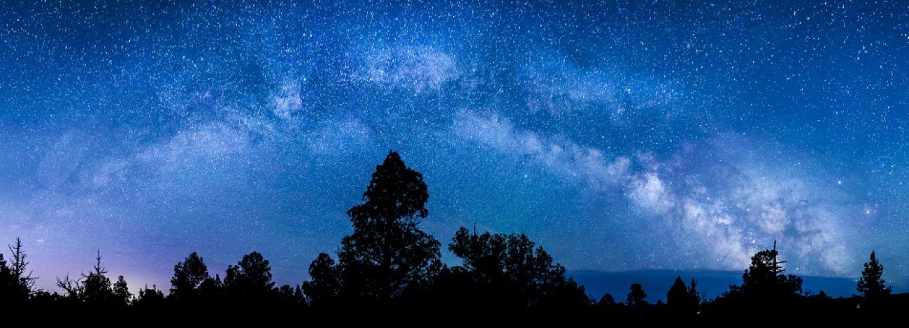 The night sky, stars, and a glowing tent within the Oregon Badlands Wilderness. Photo by Bob Wick.