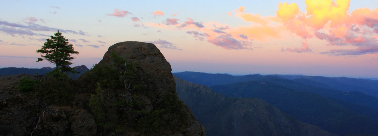 Wild Rogue Wilderness Area at sunset with clouds and mountains