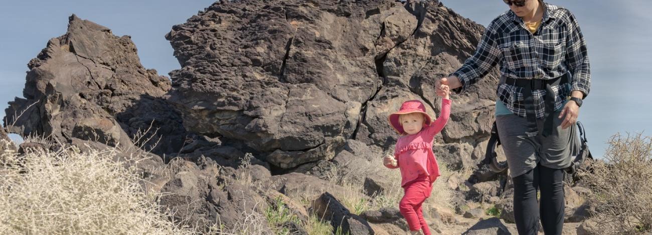 A mother and child hike on a rocky trail. Photo by Jesse Pluim, BLM.