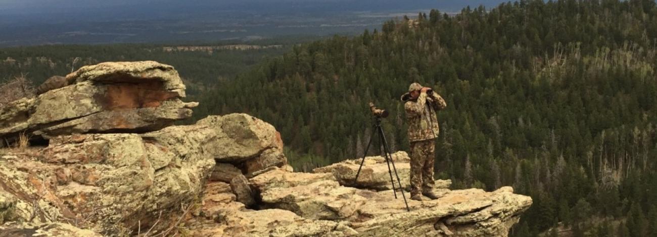 Hunter Scouting from high cliff