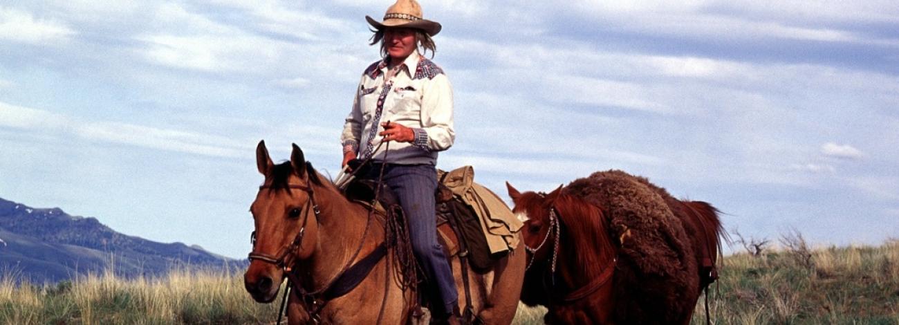 A man on horseback, with another horse following, rides along the Oregon National Historic Trail, photo by BLM