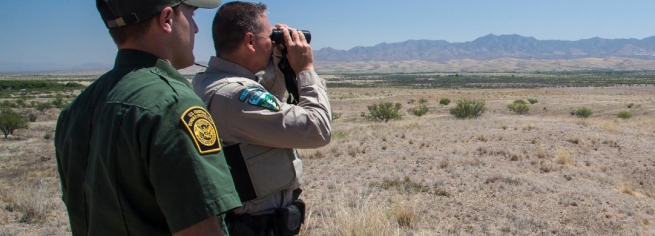 A BLM ranger joins a border patrol ranger to overlook public lands