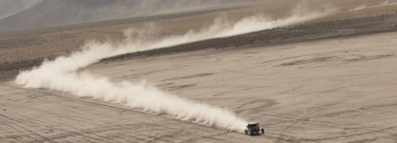 Photo of desert vehicle driving on open land. Photo by: Vince Knakal