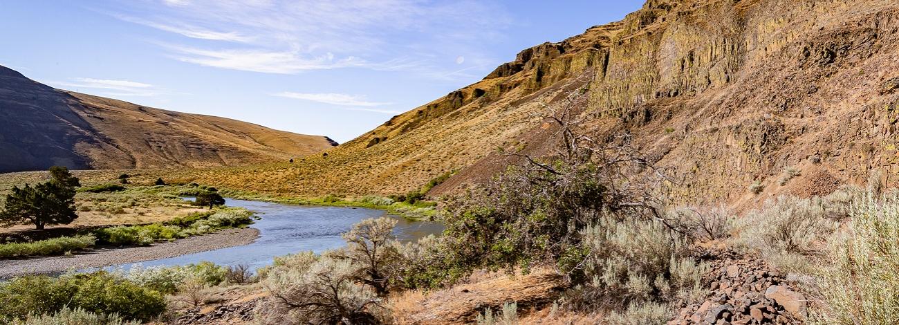 landscape photo showing river and mountains