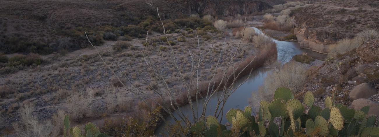 Looking down on a canyon with a river flowing through it.