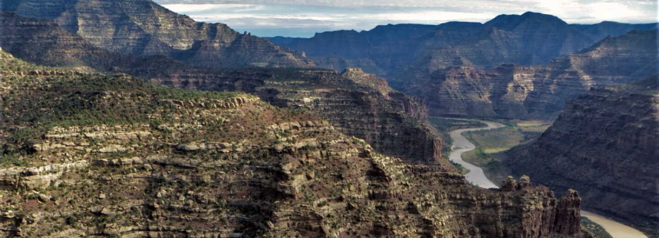 Mountain landscape with a river flowing the the canyons.