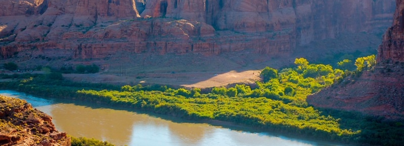 An arch with mountains and canyons. 