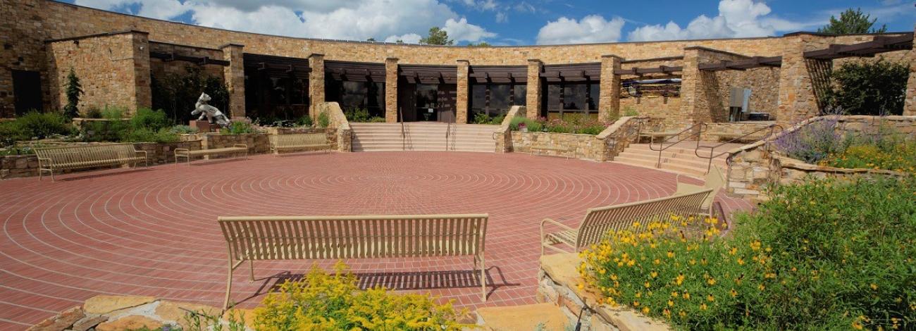 a building and courtyard, the Anazazi Heritage Center in Colorado