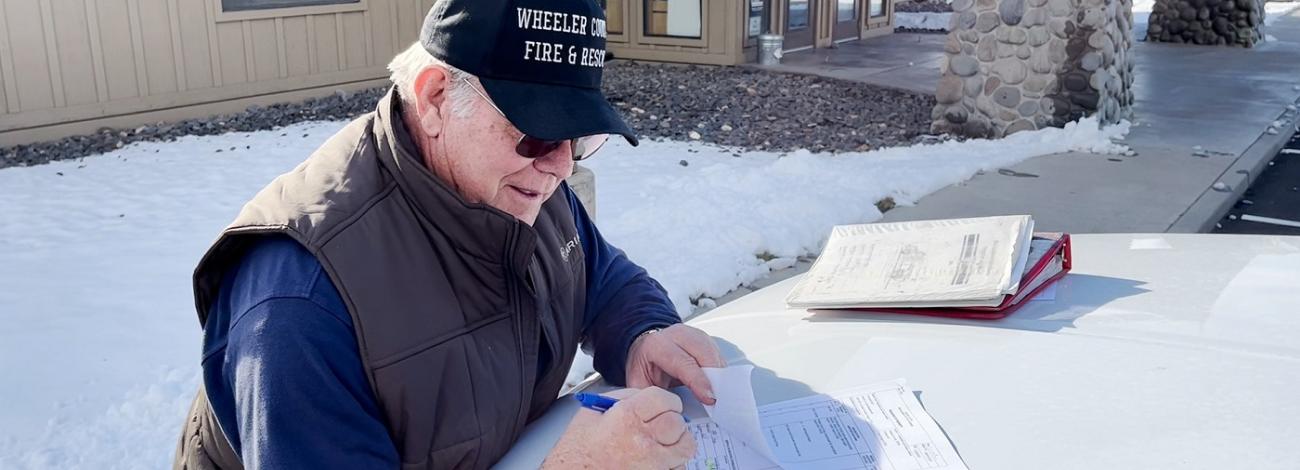 firefighter signing Rural Fire paperwork before equipment exchange