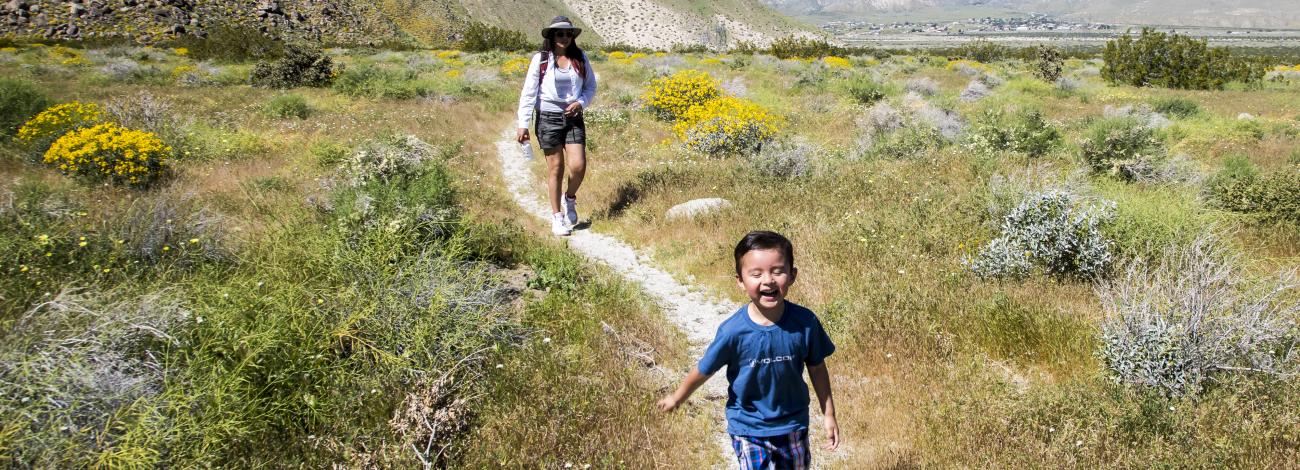 Photo of children running on a trail.