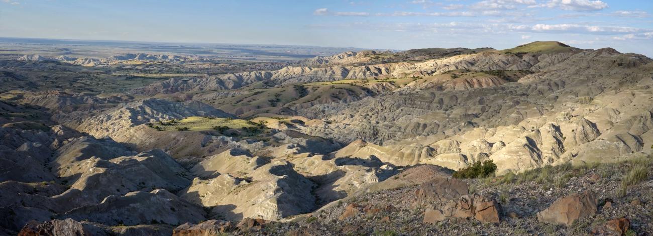 sandy hills reach out into the open barren landscape.