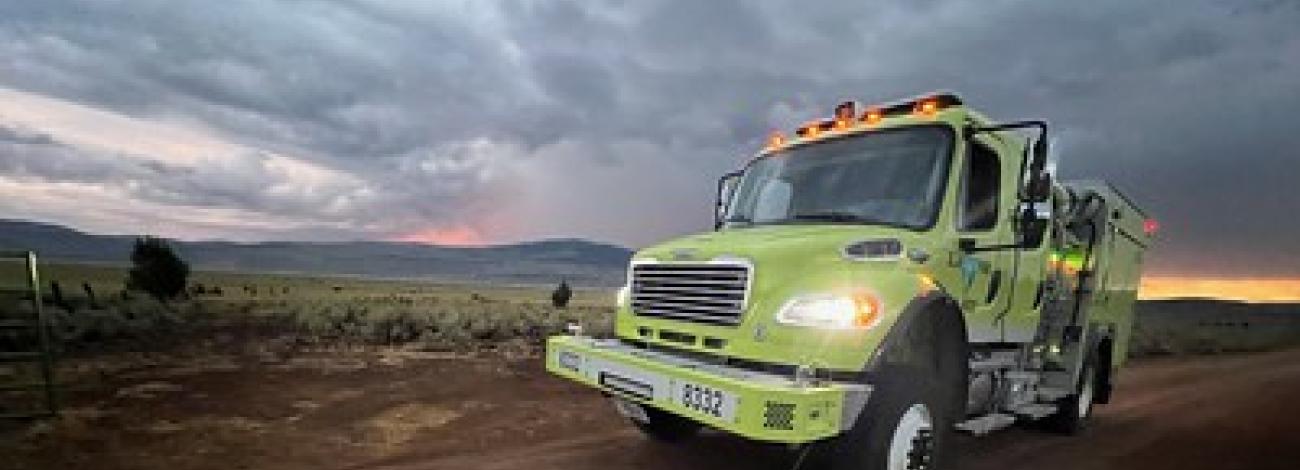 A fire engine on a dirt road