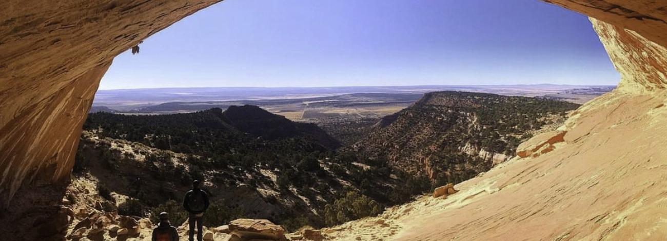 Utah desert arch frames a hilly panorama