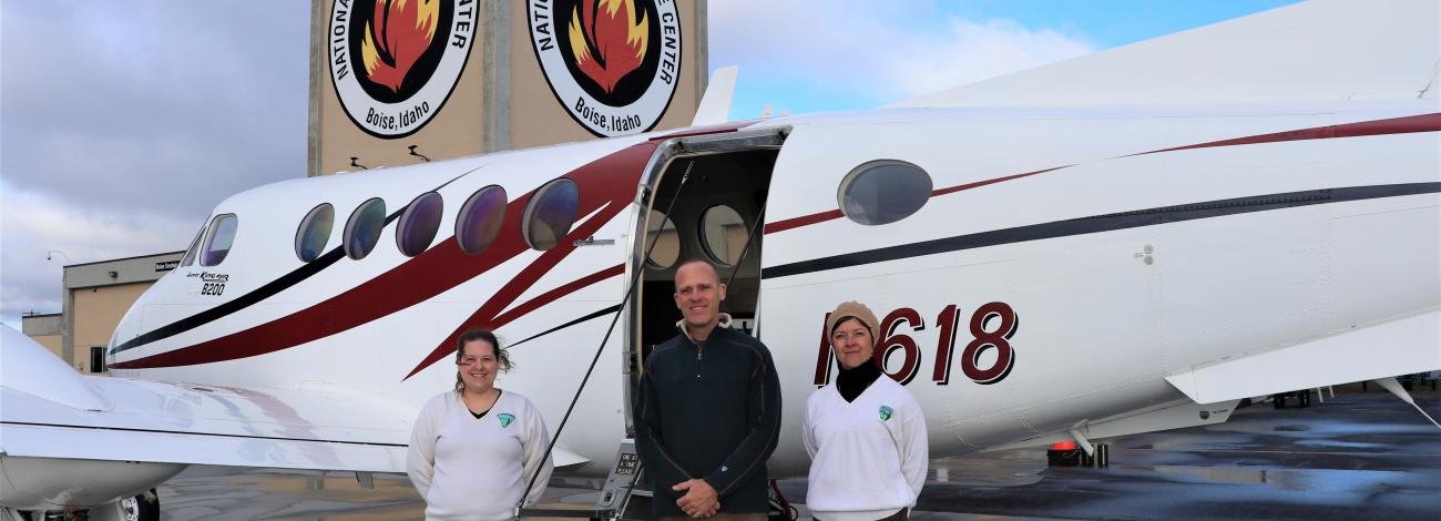 BLM Utah Curator and NAGPRA Coordinator Diana Barg (left) and Tribal Liaison Jessica Montcalm (right) with NAO Lead Plane Pilot Hans Germann (center) at National Interagency Fire Center, prepare for take-off from Boise, Idaho.