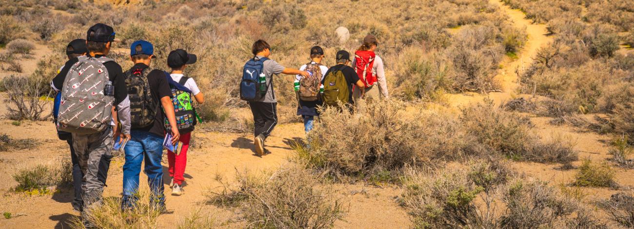 Children walking up a dirt trail