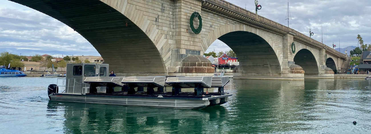 Fishery boat passes under London Bridge on return trip from installation of habitats