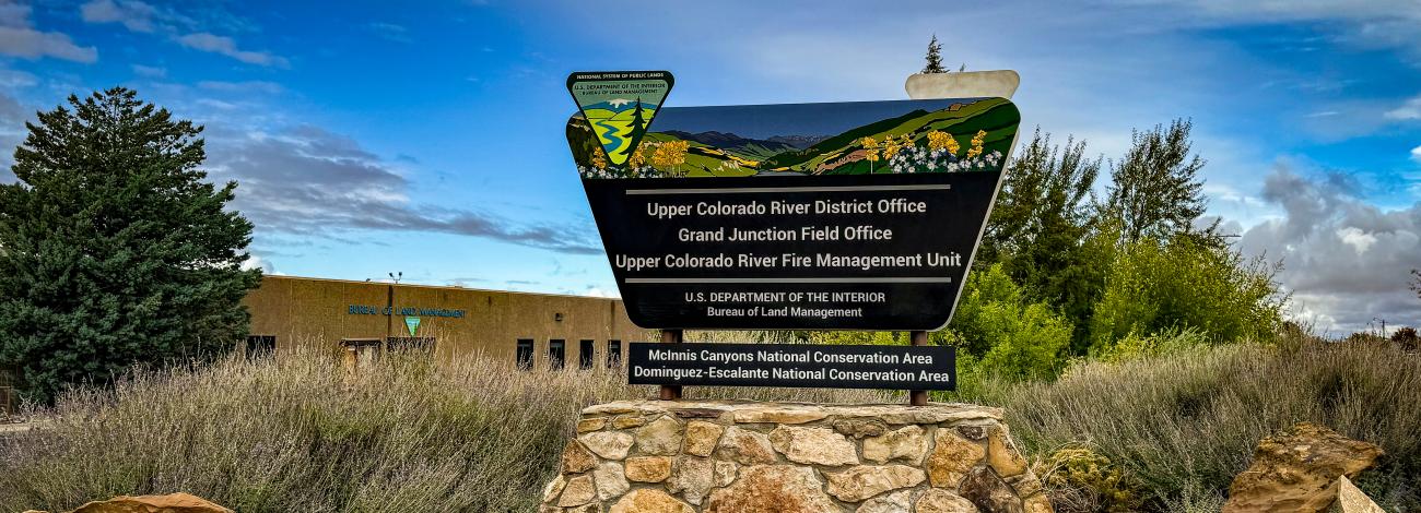 BLM Upper Colorado River District sign outside front of the building with a blue sky in background