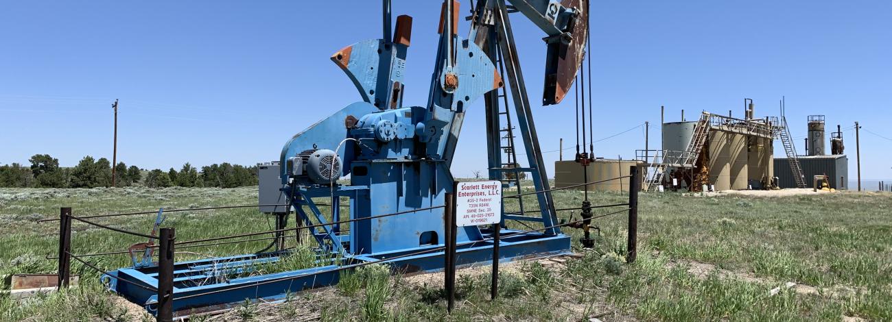 an oil well on a grassy plain