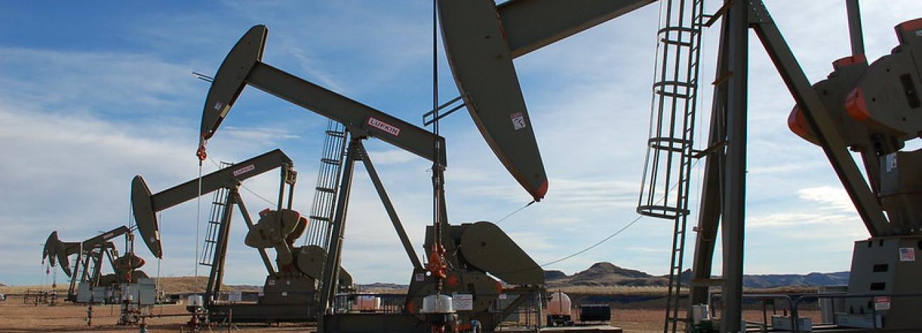 Four oil derricks pumping oil in at DASLM in North Dakota