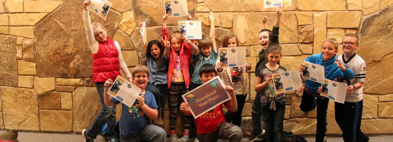 Fourth-grade students display their Every Kid in a Park passes at the NHTIC