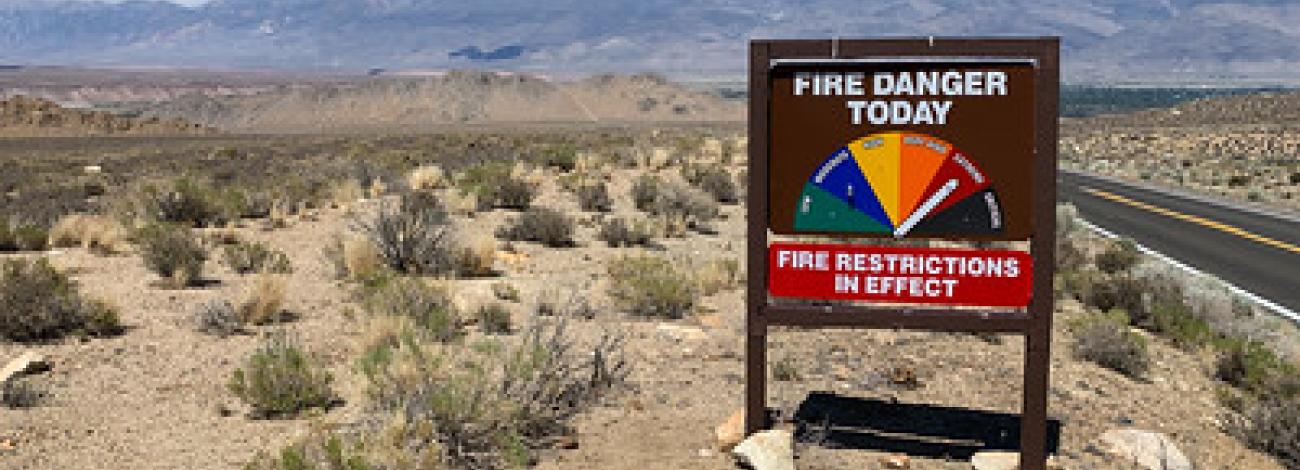 A sign in the desert indicating high fire danger