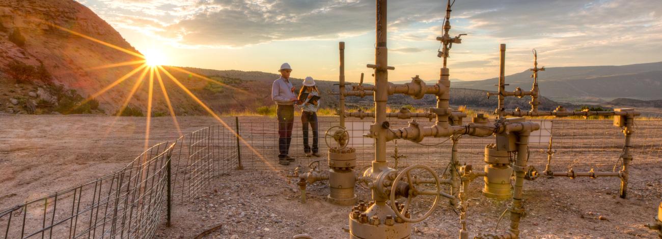 Two BLM workers at an oil and gas facility in Colorado.