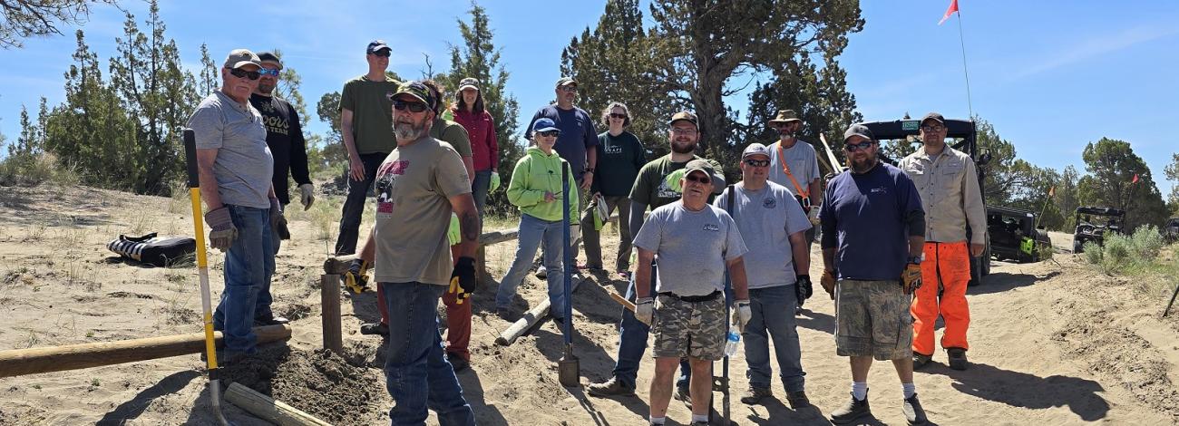 group of volunteers repairing fencing