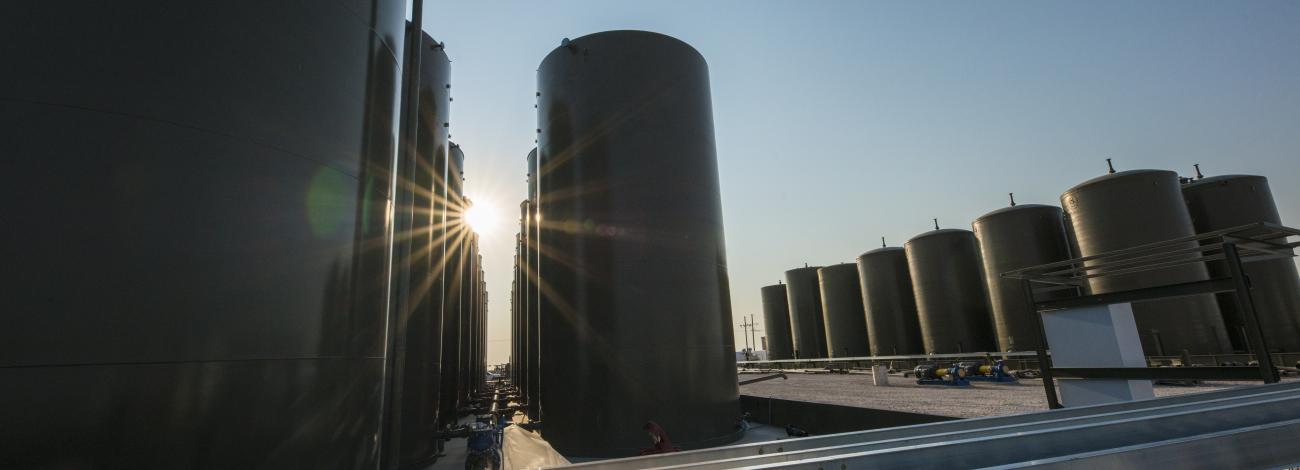 The sun shines through storage tanks at an oil pipeline system in New Mexico.