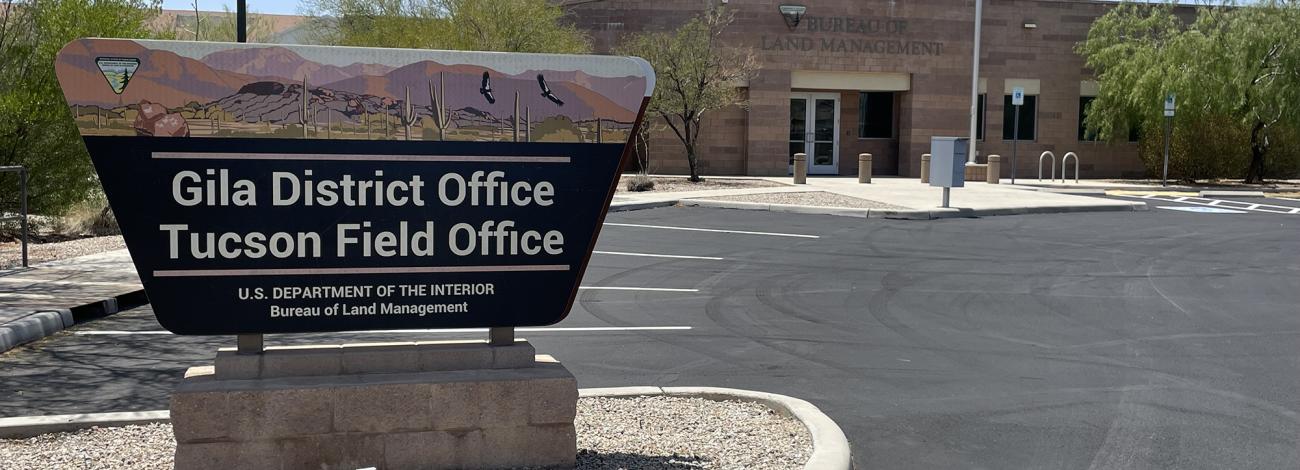 Gila District and Tucson Field office sign in front of an office building with an American flag