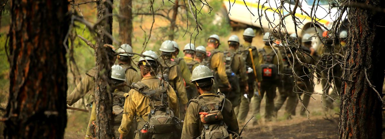 Veteran crew walking back to truck after fighting a wildfire in Montana MY Complex fire in 2021