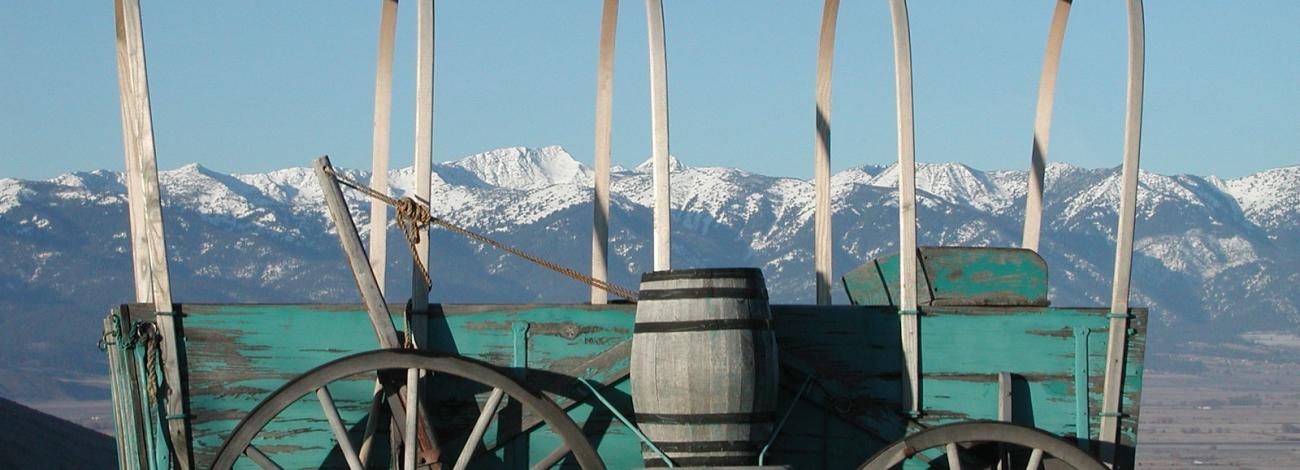 wagon without canvas and snowy mountains in distance