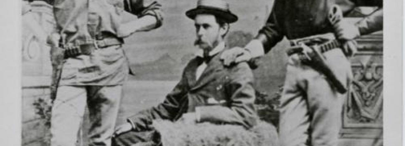 Black and white photo of three men wearing hats