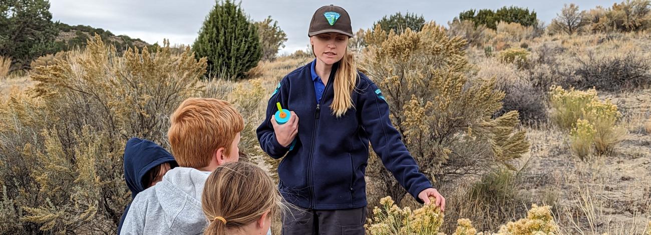 Ranger pointing to sagebrush during education program for children