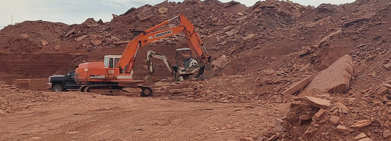 Machinery at the rock face of the Bitter Seep Community Pit loading up red sandstone speciality rock.
